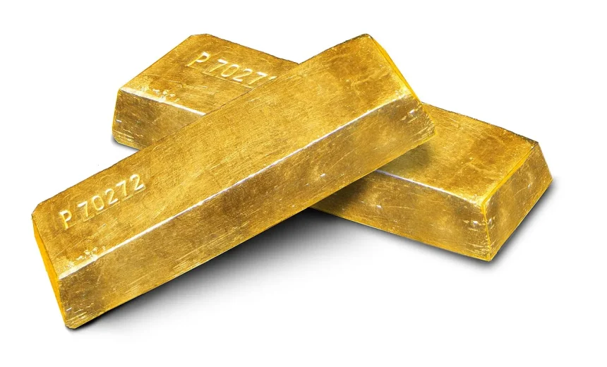 Gold ingots arranged on a plain background, photographed as a store of value.