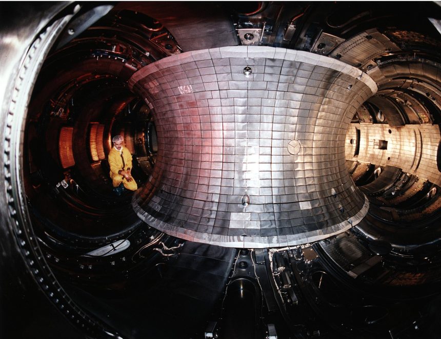 The glowing interior of a tokamak fusion reactor during an experiment