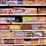 Supermarket shelves with packaged foods and nutrition labels