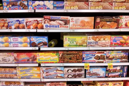 Supermarket shelves with packaged foods and nutrition labels