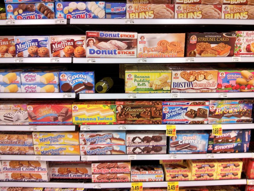Supermarket shelves with packaged foods and nutrition labels